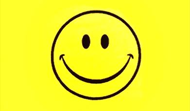 The classic 1990s symbol for acid house music featuring a yellow smiley face with oval eyes