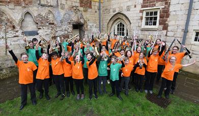 Group of children holding brass instruments