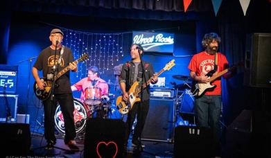 Band members of Abdoujaparov performing live on stage: Les Carter (Lead Vocals & Guitar), Richy Crockford (Bass & Backing Vocals), Adam Bomber (Drums 