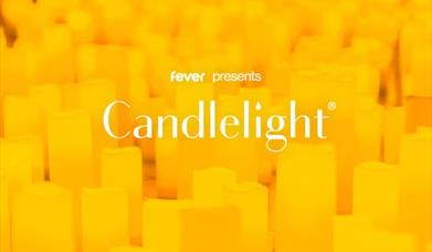 Hundreds of candles glowing in a dark room