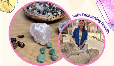 A smiling woman standing in front of a giant crystal and several smaller brightly coloured crystals on a table