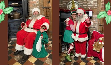A smiling bearded man in a red velvet suit with white trim hugging a woman dressed as an elf next to a Victorian fireplace