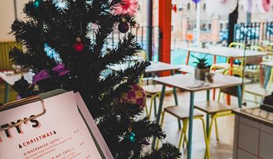 A colourful Christmas tree and decorations are up in the café.
