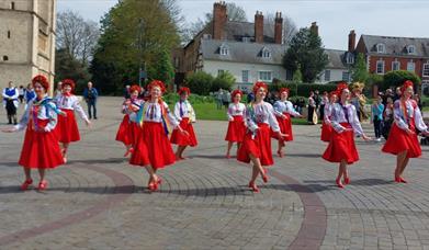 A group of women dancing in traditional Ukrainian dress