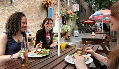 People eating at a table outside Cafe Rene