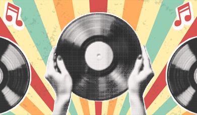 A pair of hands holding a vinyl record