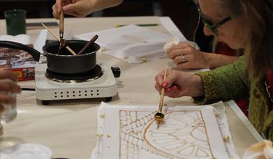 Women creating images using batik
