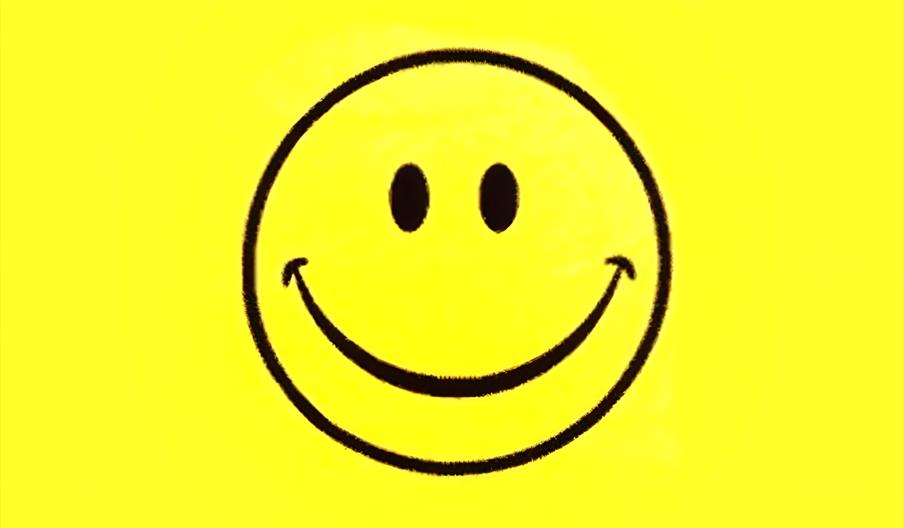 The classic 1990s symbol for acid house music featuring a yellow smiley face with oval eyes