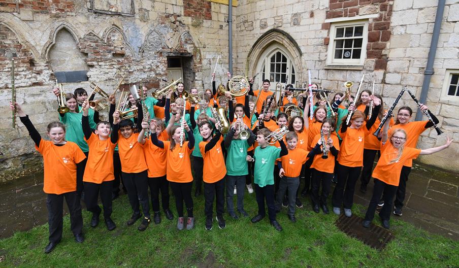 Group of children holding brass instruments