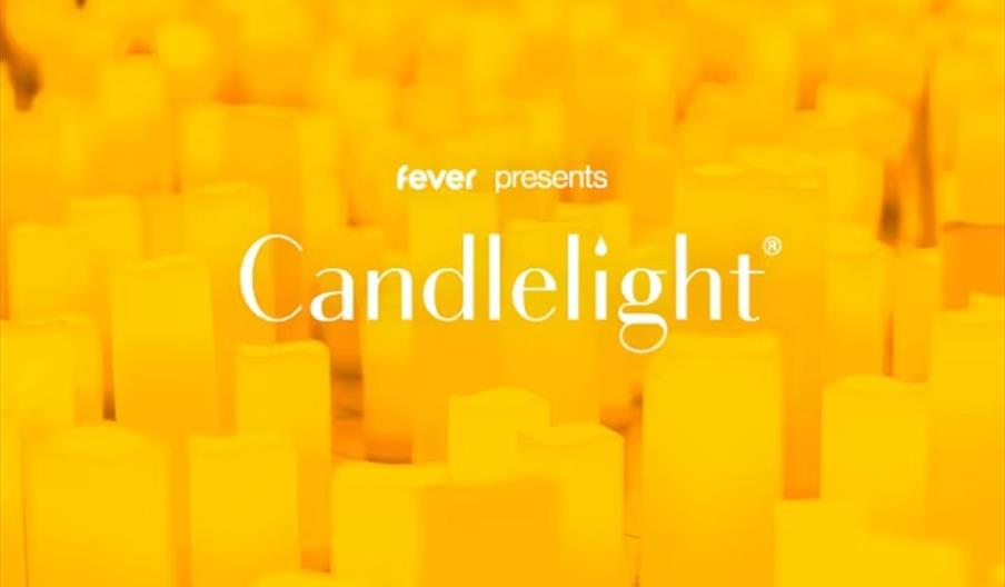 Hundreds of candles glowing in a dark room