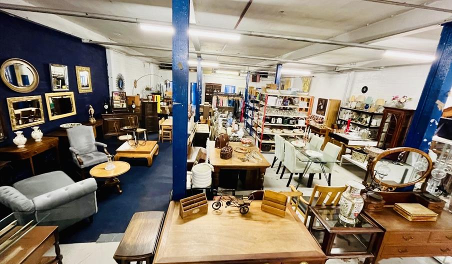 A vintage warehouse shop filled with antiques, furniture, and quirky collectables