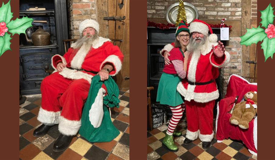 A smiling bearded man in a red velvet suit with white trim hugging a woman dressed as an elf next to a Victorian fireplace