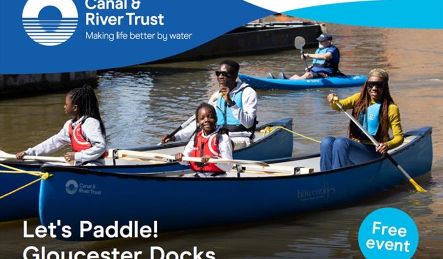 a family paddles on the water in canoes