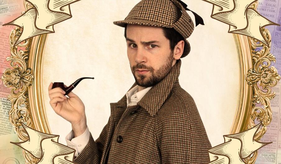 A young man in a deerstalker hat and a Gabardine cape holding a pipe and looking pensive