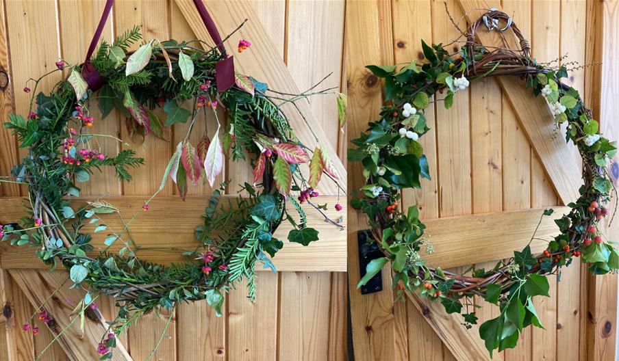 Two wreathes made from evergreen foliage with bright berries