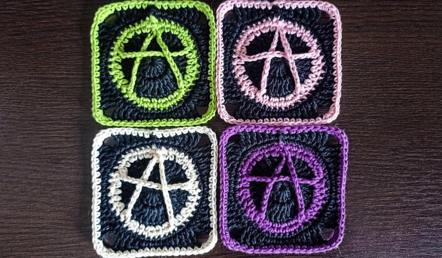 Four fabric patches showing the Anarchy symbol in different colours.