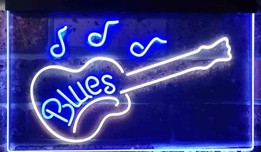 A blue neon bar sign with the outline of a guitar surrounding the word, blues.