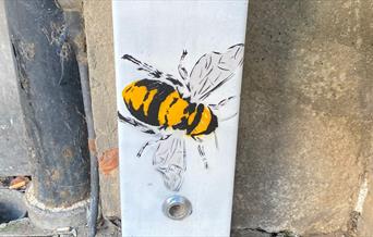 A bee painted on a fuse box