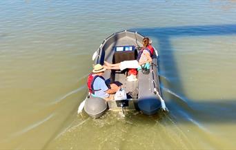 Couple relaxing on hire boat in Gloucester Docks