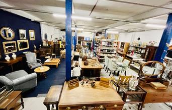 A vintage warehouse shop filled with antiques, furniture, and quirky collectables