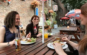 People eating at a table outside Cafe Rene