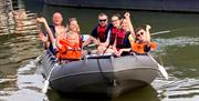 Family waving on hire boat