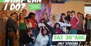 A group of young people stood together on stage at The Music Works - Text says What Can I Do? Saturday 30th August. JOLT & The Music Works