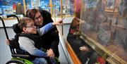 Mum and son viewing the displays at the Museum of Gloucester