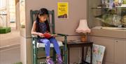 Child reading Ladybird Books at museum of Gloucester