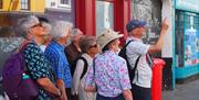 One of our guides pointing out the unique 26 Westgate Street , explaining its 500 year contribution to Gloucester's street scene.