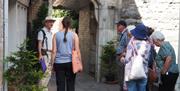 A Civic Trust guide explaining the history behind the 'Beatrix Potter ' shop in College Walk.