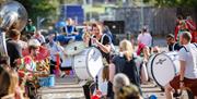 Dancers and musicians all together in the street as part of the parade