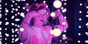 Girl performing live within the Submergence lights