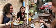 People eating at a table outside Cafe Rene