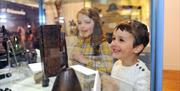 children discovering the artifacts in cabinet at the Museum of Gloucester