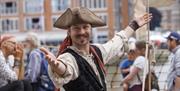 A member of a Tall Ship crew welcoming you to Tall Ships.