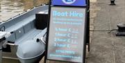 Gloucester Boat Hire Sign with boats in background
