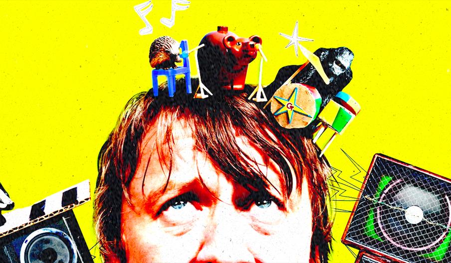 Kid Carpet looking sad with toy animals on his head.