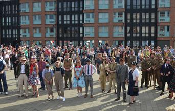 A group of people dressed for the Gloucester Goes Retro festival