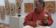 A man doing wood-carving