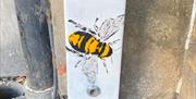 A bee painted on a fuse box