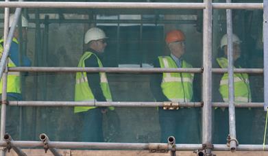 men standing on scaffolding